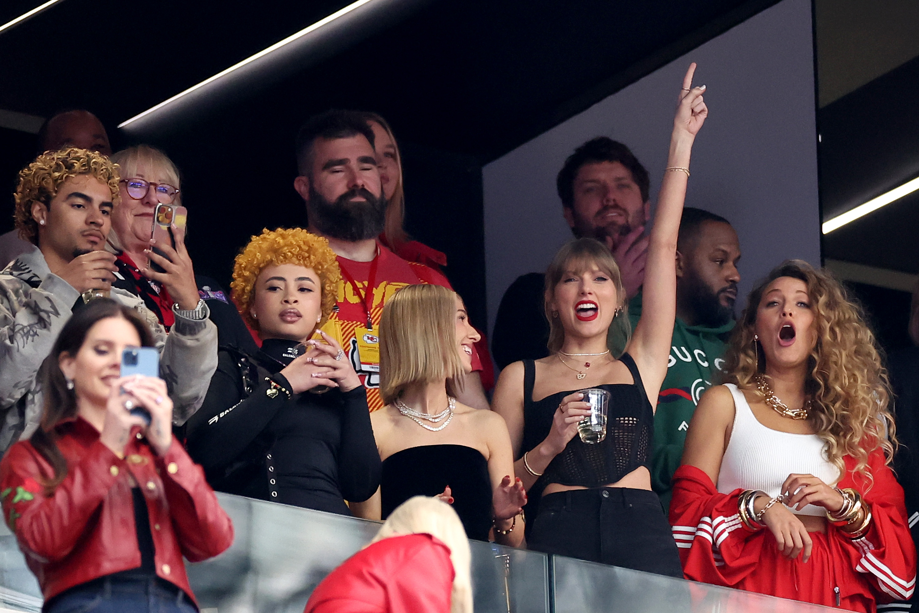 Rapper Ice Spice, Singer Taylor Swift and Actress Blake Lively standing at the Super Bowl