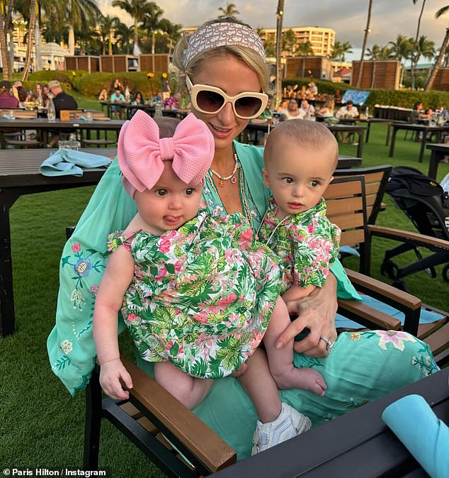 On Wednesday, Hilton cuddled with her two babies while watching the sunset with Carter at the beach